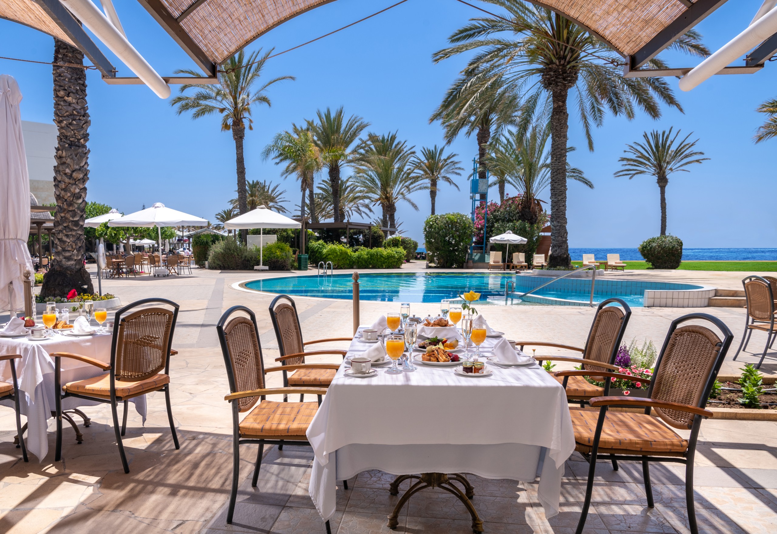 Breakfast served poolside at Asimina Suites, a stunning 5* Paphos resort on the beach.